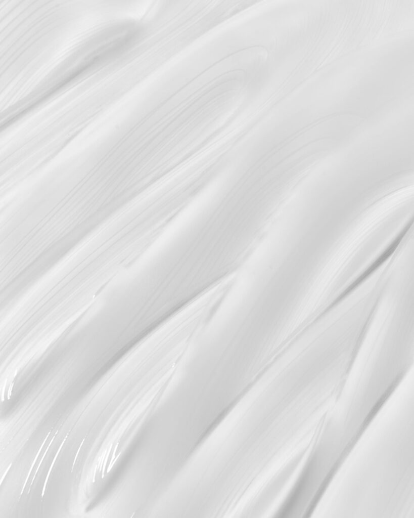 High-resolution close-up of smooth white paint texture with abstract patterns, ideal for backgrounds.